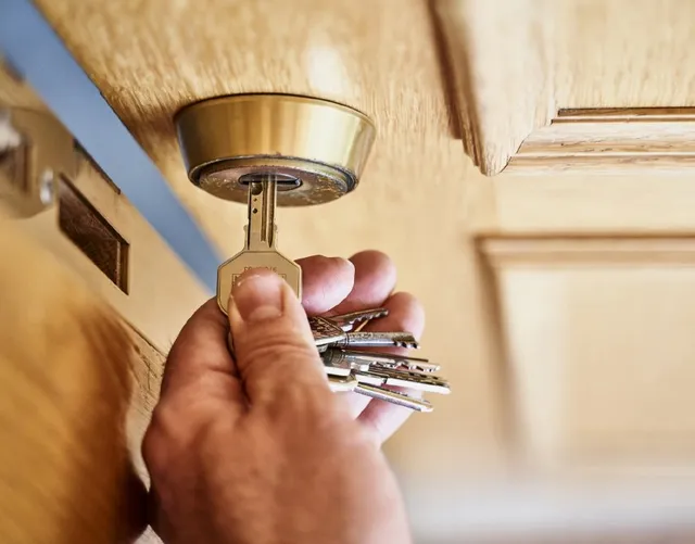 Close-up of key inserted in door lock symbolizing locksmith services