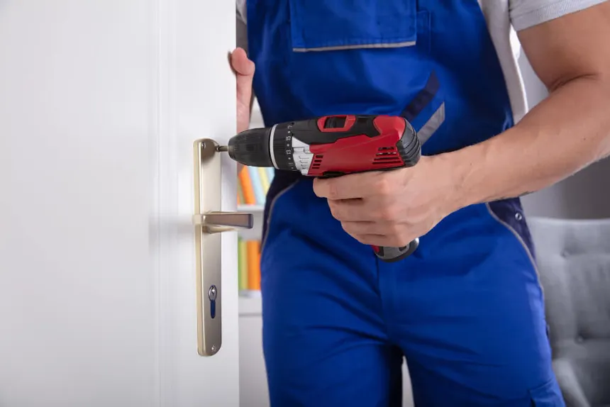 Professional locksmith using tools to open locked car in emergency situation