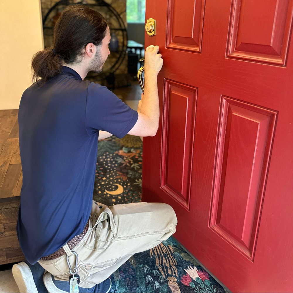 Residential locksmith repairing a home door lock for Winston-Salem homeowners