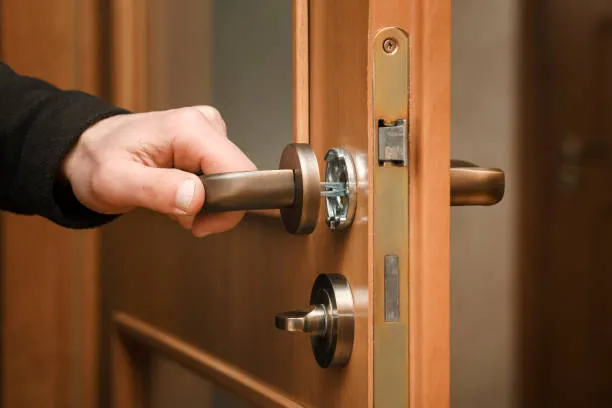 Residential locksmith repairing front door lock for a homeowner in Winston-Salem